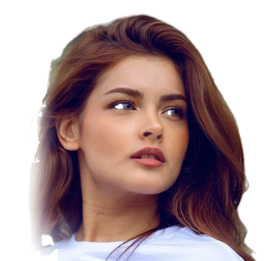 A woman with long auburn hair in a white t-shirt, glancing over her shoulder